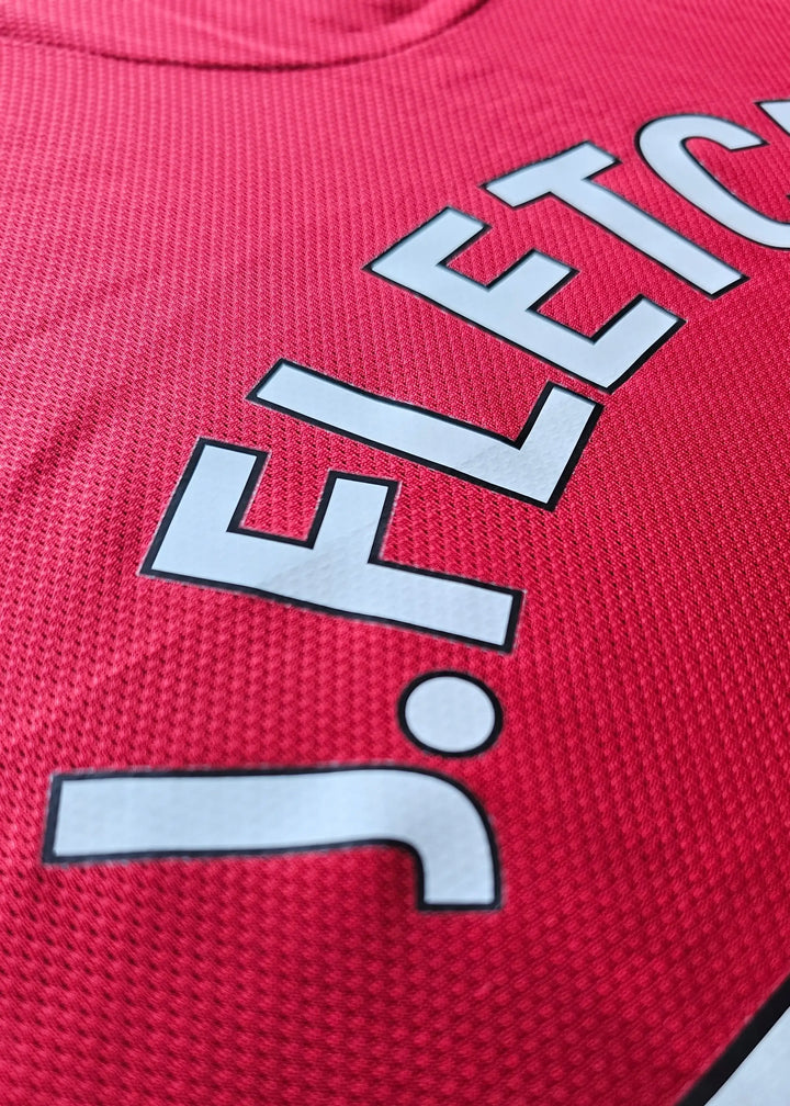 Close-up view of the name 'Fletcher' with a signature detail on a red football shirt.