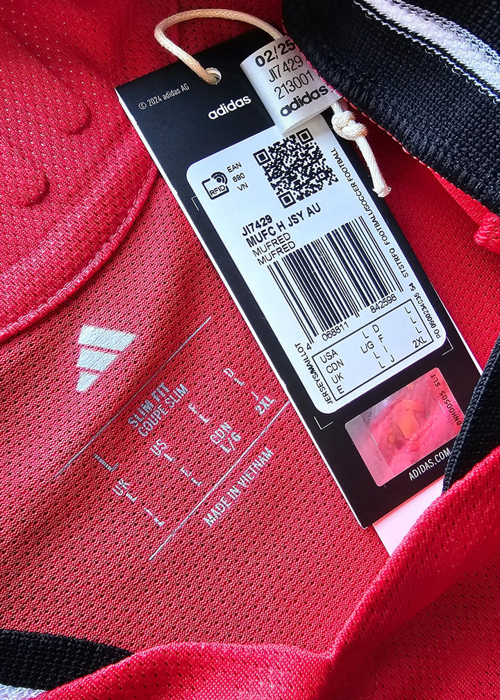 Label detail showing adidas branding and size information on a red football shirt.