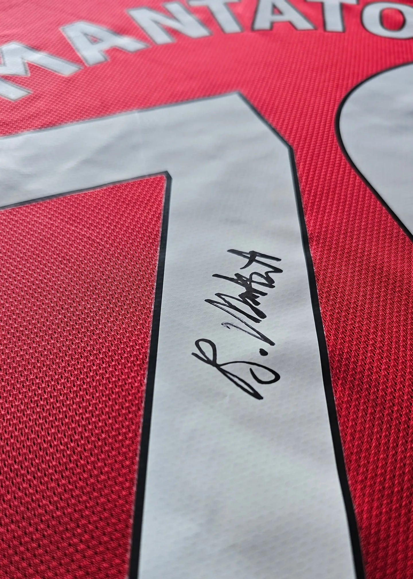 Back view showing No. 30 and Bendito Mantato's signature on the red football shirt.