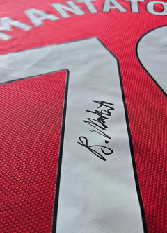 Back view showing No. 30 and Bendito Mantato's signature on the red football shirt.