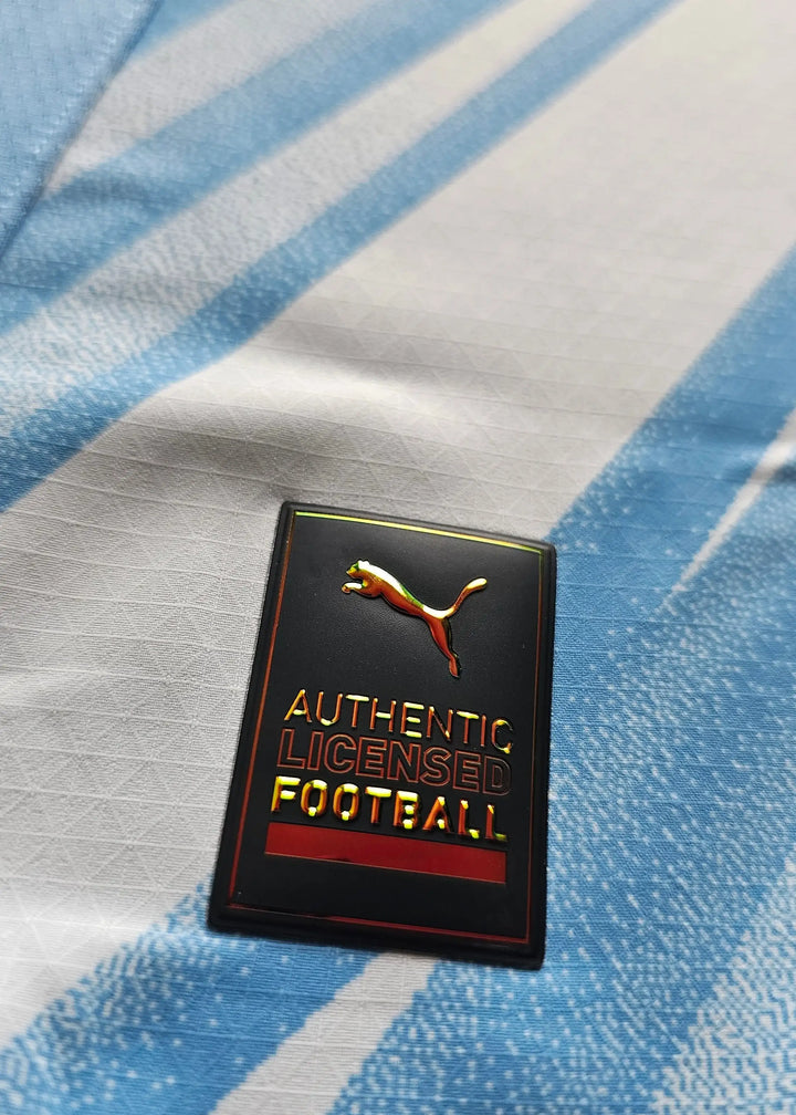 Crest detail showcasing the Puma logo alongside the text 'AUTHENTIC LICENSED FOOTBALL.'.