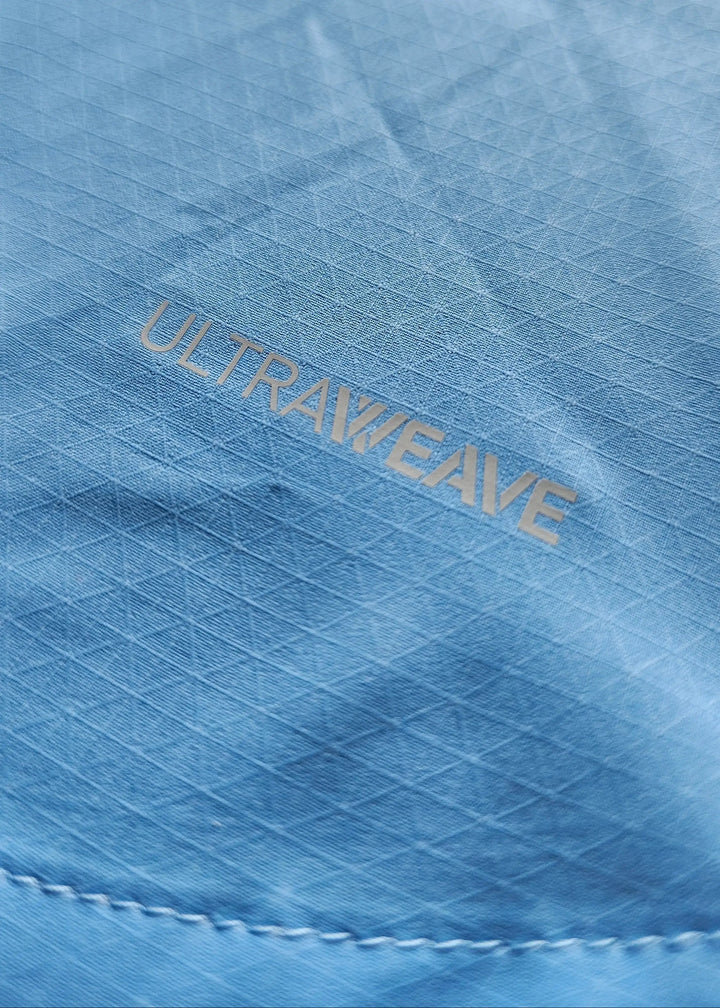 Close-up of blue fabric with embossed 'ULTRAWEAVE' pattern.