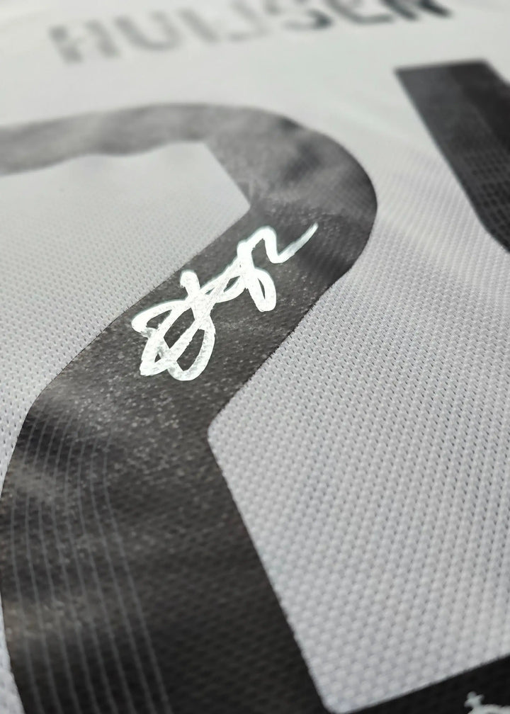 Close-up of No. 24 with the signature of Huijsen on a white football shirt.