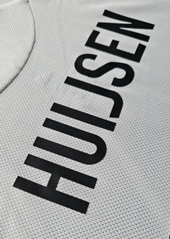 Close-up showing the name Huijsen in black on a white football shirt.