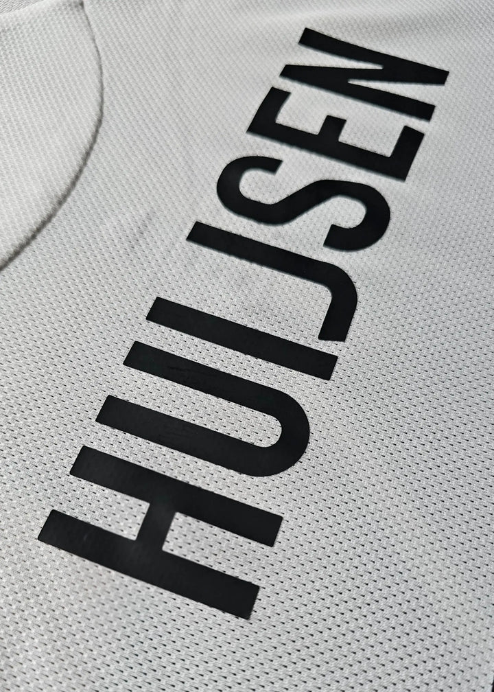 Close-up showing the name Huijsen in black on a white football shirt.