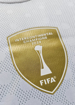 Crest detail featuring Intercontinental Champions 2024 emblem and FIFA logo.