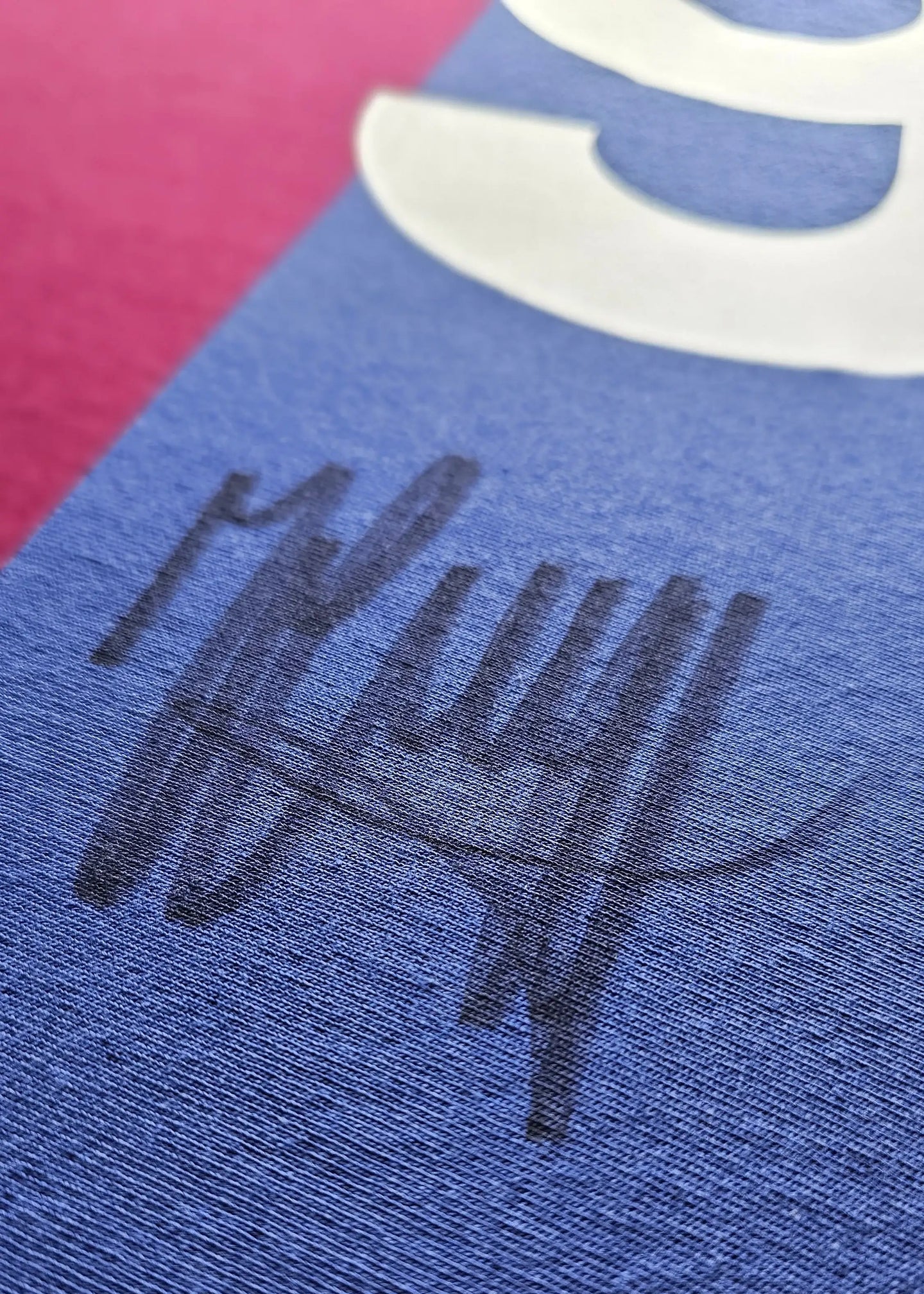 Close-up showing the signature of Johan Cruyff on a blue section of the football shirt.