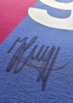 Close-up showing the signature of Johan Cruyff on a blue section of the football shirt.