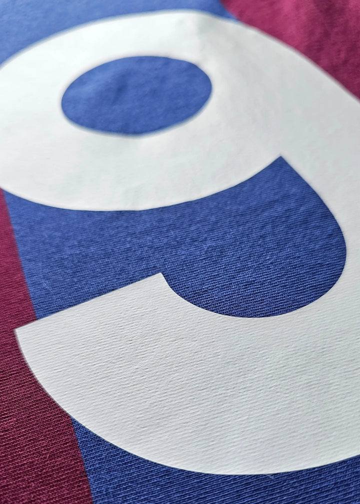 Close-up view of the No. 9 and signature detail on the signed Johan Cruyff Barcelona shirt.