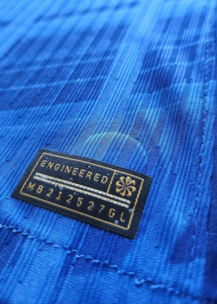 Close-up of the embroidered tag featuring &