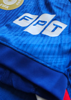Close-up of the blue fabric featuring the FPT logo and FIFA badge.