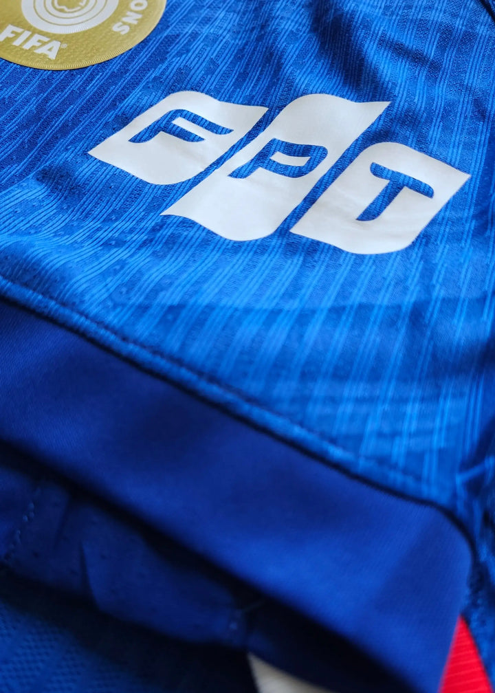 Close-up of the blue fabric featuring the FPT logo and FIFA badge.