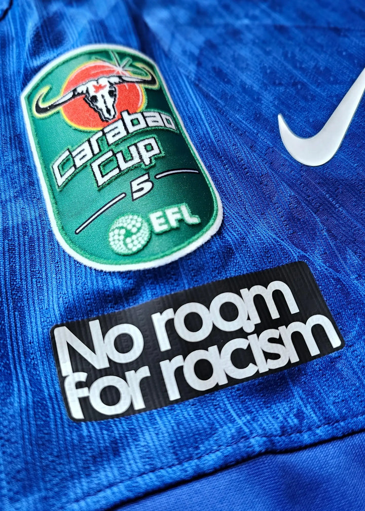 Crest detail showing Carabao Cup badge with EFL text and 'No room for racism' message.