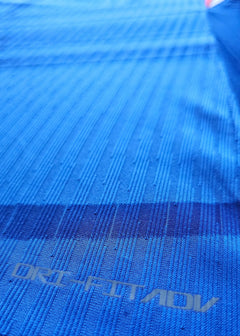 Detail of blue fabric showing ORI-FITADV text on the signed Jorrel Hato Chelsea shirt.