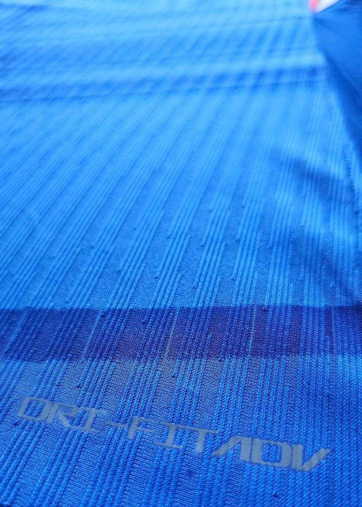 Detail of blue fabric showing ORI-FITADV text on the signed Jorrel Hato Chelsea shirt.