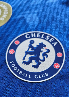 Close-up of Chelsea Football Club crest featuring a blue lion and flowers.