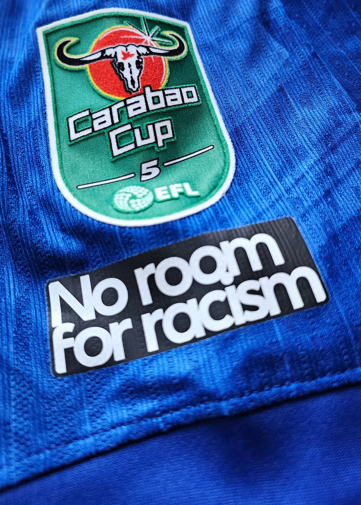 Crest detail featuring the Carabao Cup logo and the slogan &