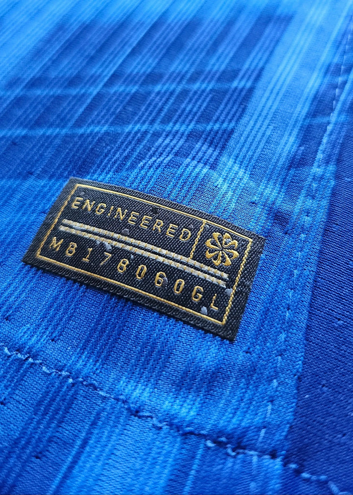 Close-up showing engineered label with text 'ENGINEERED MB178060GL' on blue fabric.