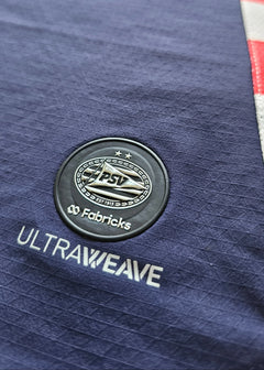 Detail view showing PSV crest with two stars, and the text 'ULTRAWEAVE' and 'Fabricks'.