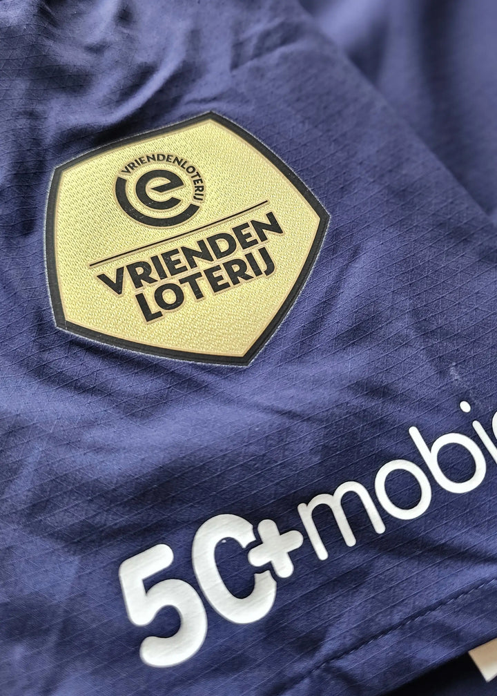 Detail showing the PSV Eindhoven sponsor logo 'VRIENDEN LOTERIJ' on a navy background.