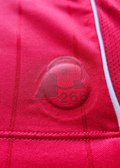 Detail view showing red crest with number 266 and wheel emblem.