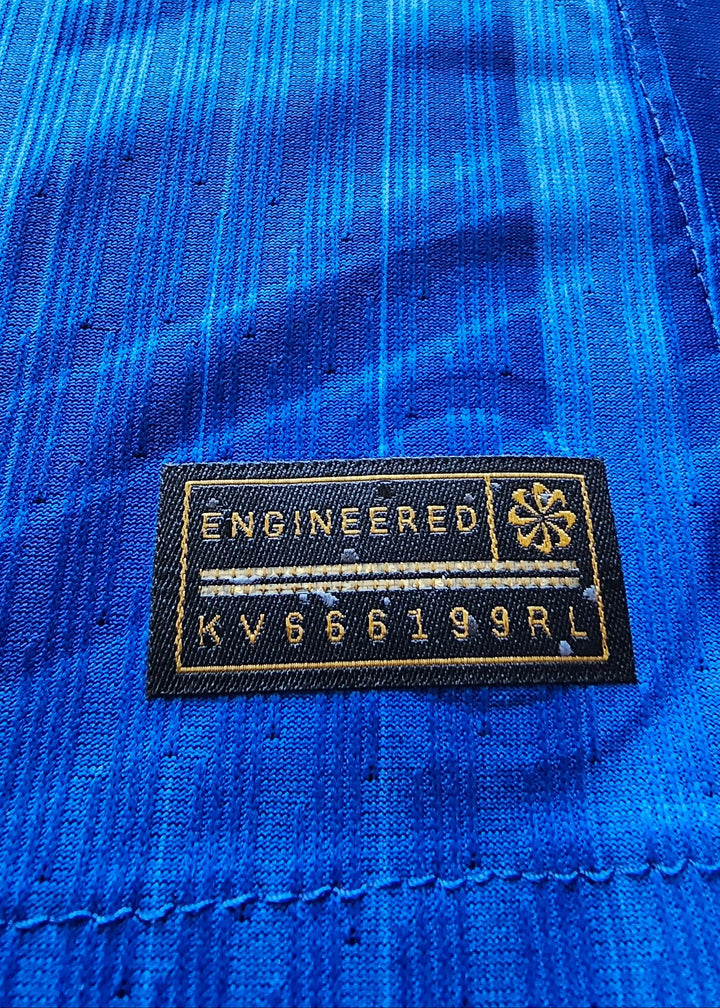 Close-up of the label showing 'ENGINEERED' and code KVB66199RL on blue fabric.