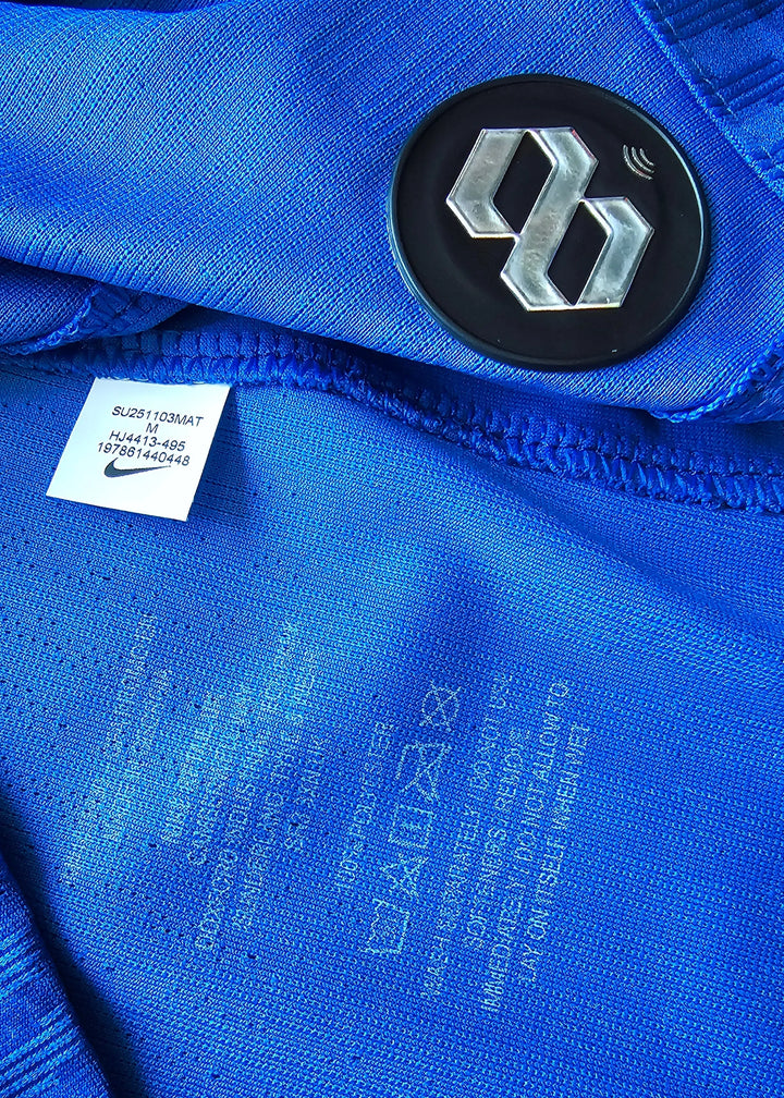 Detail view showing Nike label and care instructions on a blue football shirt.