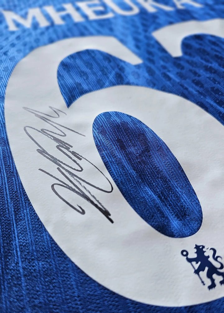 Detailed view of No. 62 with signature on Chelsea blue football shirt.