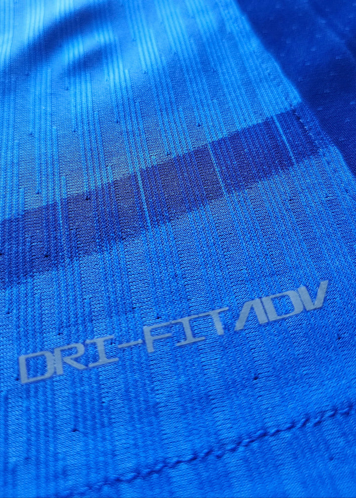 Close-up showing DRI-FIT on the blue fabric with a textured design.