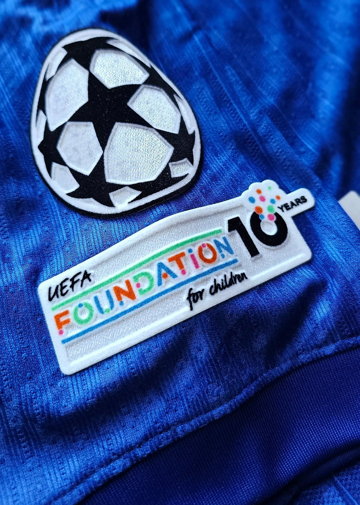 Detail showing UEFA Foundation for children logo and decorative football ball design.