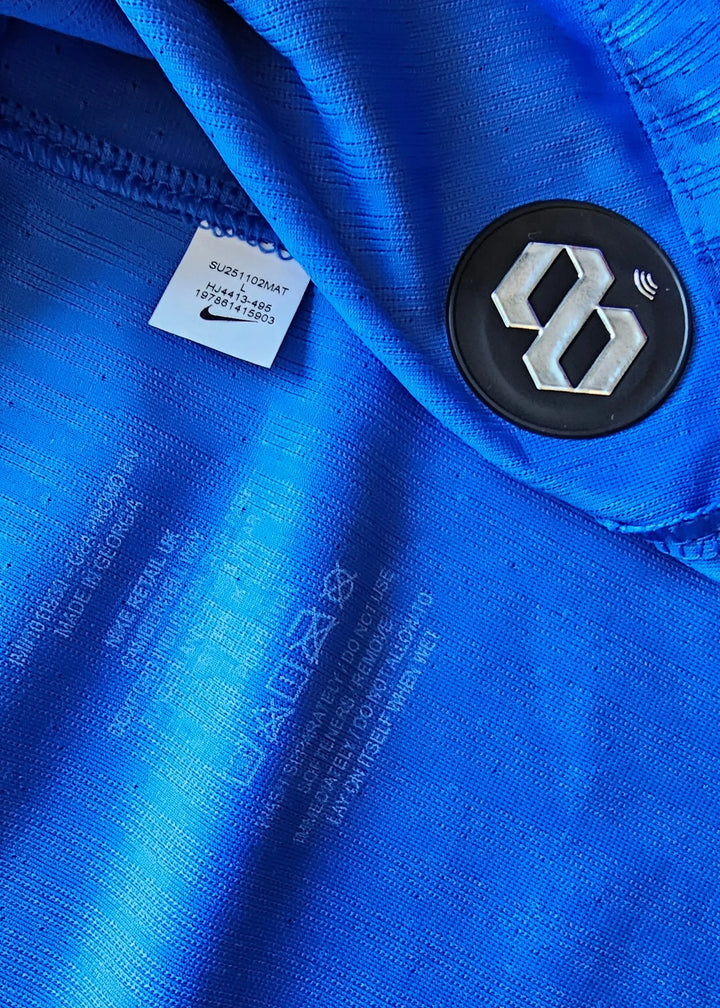 Close-up view showing blue fabric and Nike tag with sizing information.