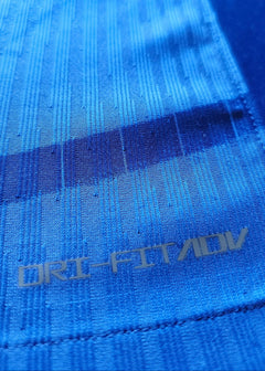 Close-up detail showing the DRI-FIT ADV text on the blue fabric.