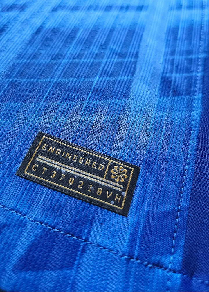 Close-up detail of a blue fabric with 'ENGINEERED' tag and code 'CT970218VH'.