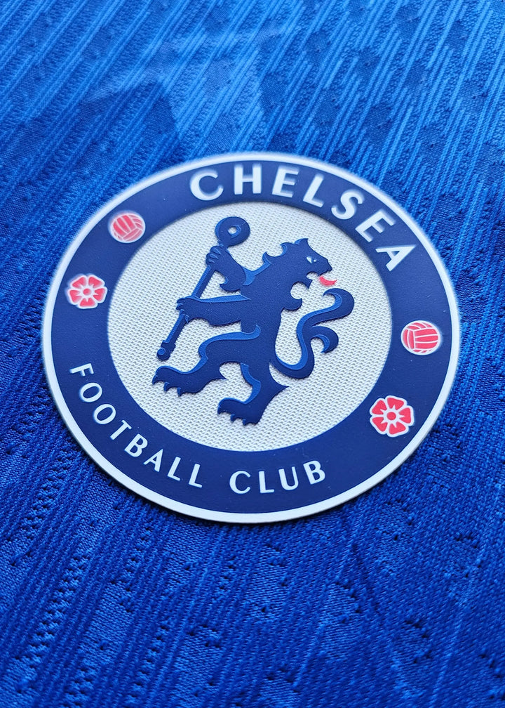 Crest detail of Chelsea Football Club featuring a blue lion and the text 'CHELSEA FOOTBALL CLUB'.