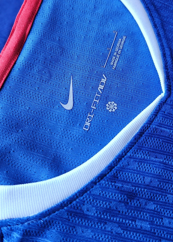Close-up of neck label displaying Nike DRI-FIT ADV technology details and care instructions.