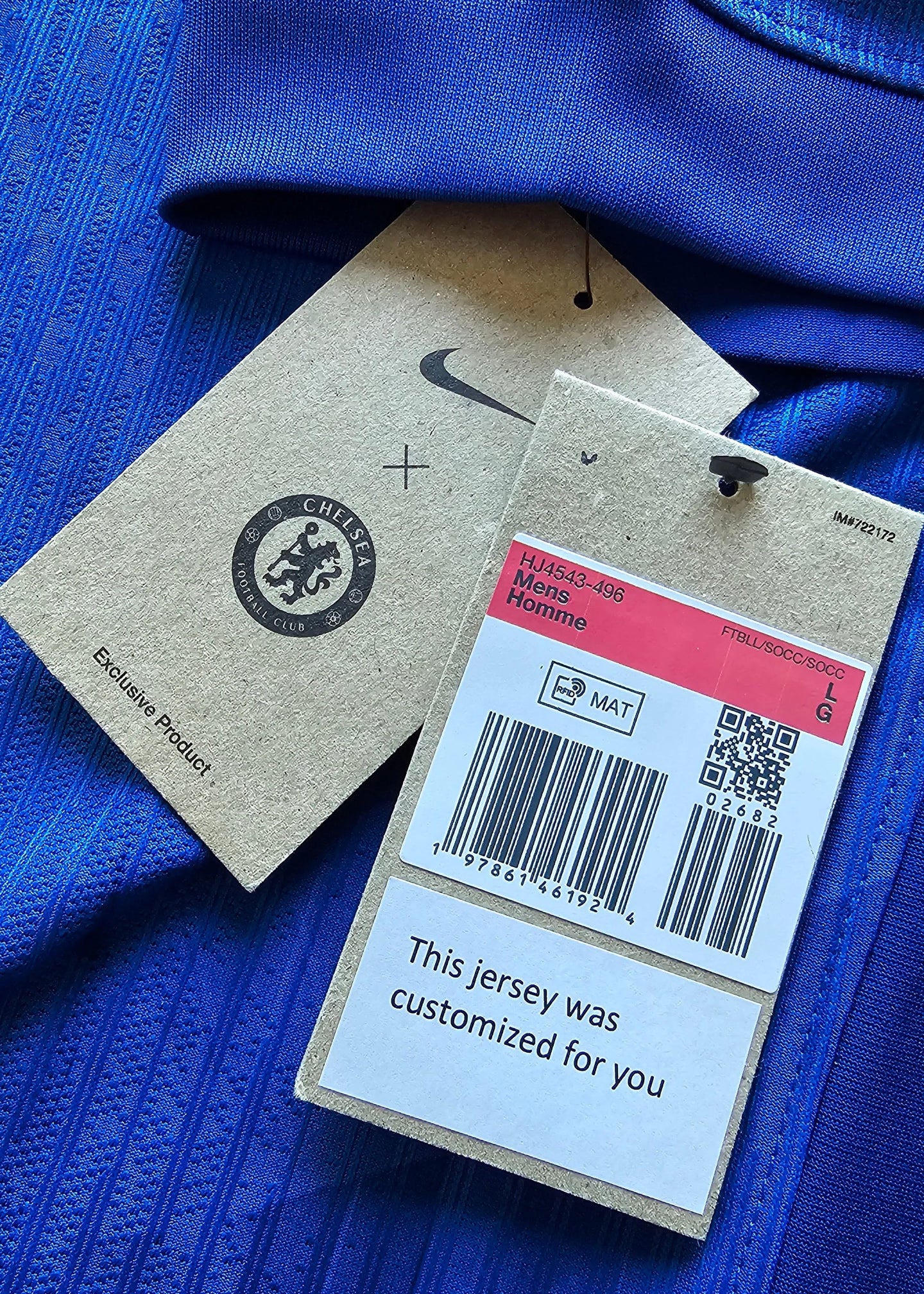 Close-up of Chelsea F.C. tags showing logo, size LG, and "This jersey was customized for you".