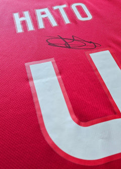 Back view displaying name 'HATO', squad number '4', and a visible signature.