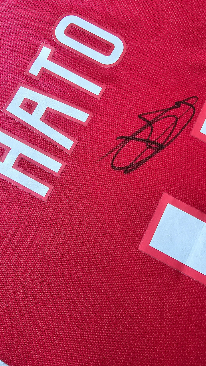 Close-up of the signed name 'Hato' and No. 4 on a red football shirt from AFC Ajax.
