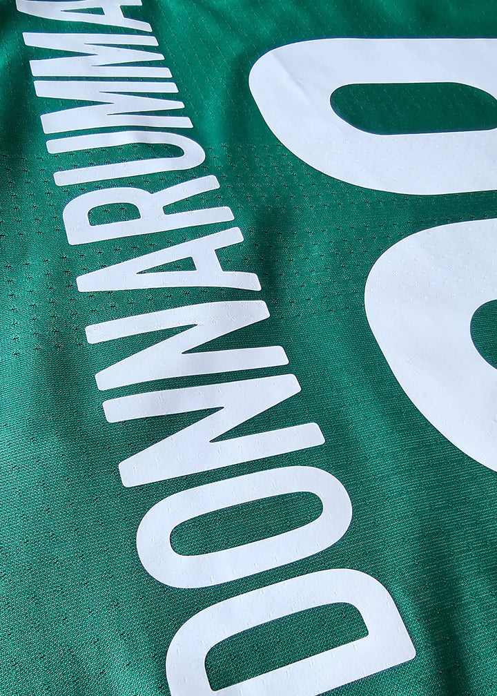 Close-up view of the No. 99 and name Donnarumma in white on a green football shirt.