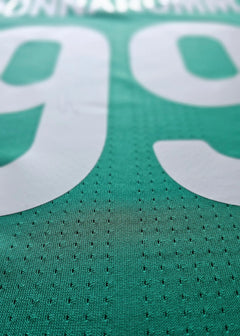 Close-up view showing No. 99 and name Donnarumma on a green football shirt.