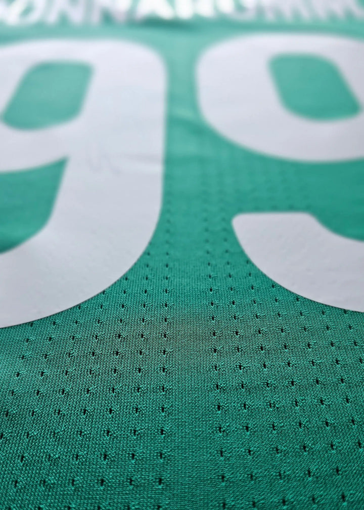 Close-up view showing No. 99 and name Donnarumma on a green football shirt.