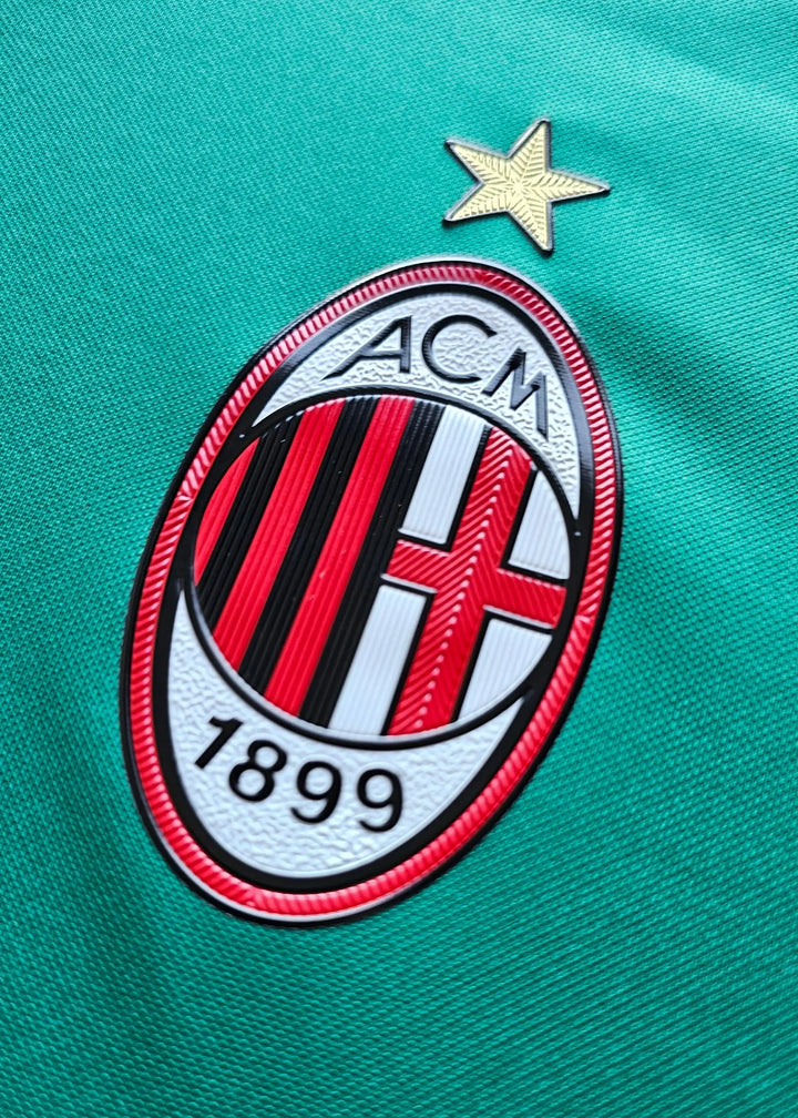 Close-up of AC Milan crest featuring a golden star and text &