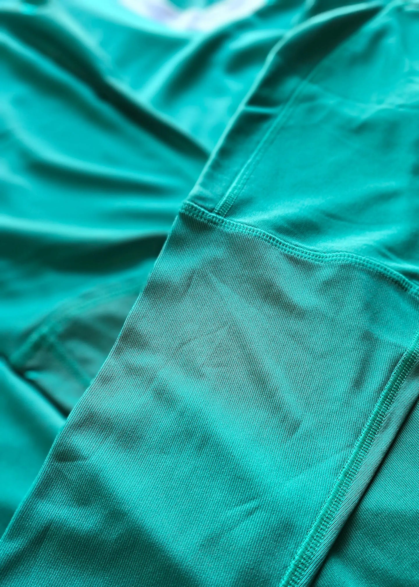 Close-up view of the fabric texture and stitching details of a signed Gianluigi Donnarumma football shirt.