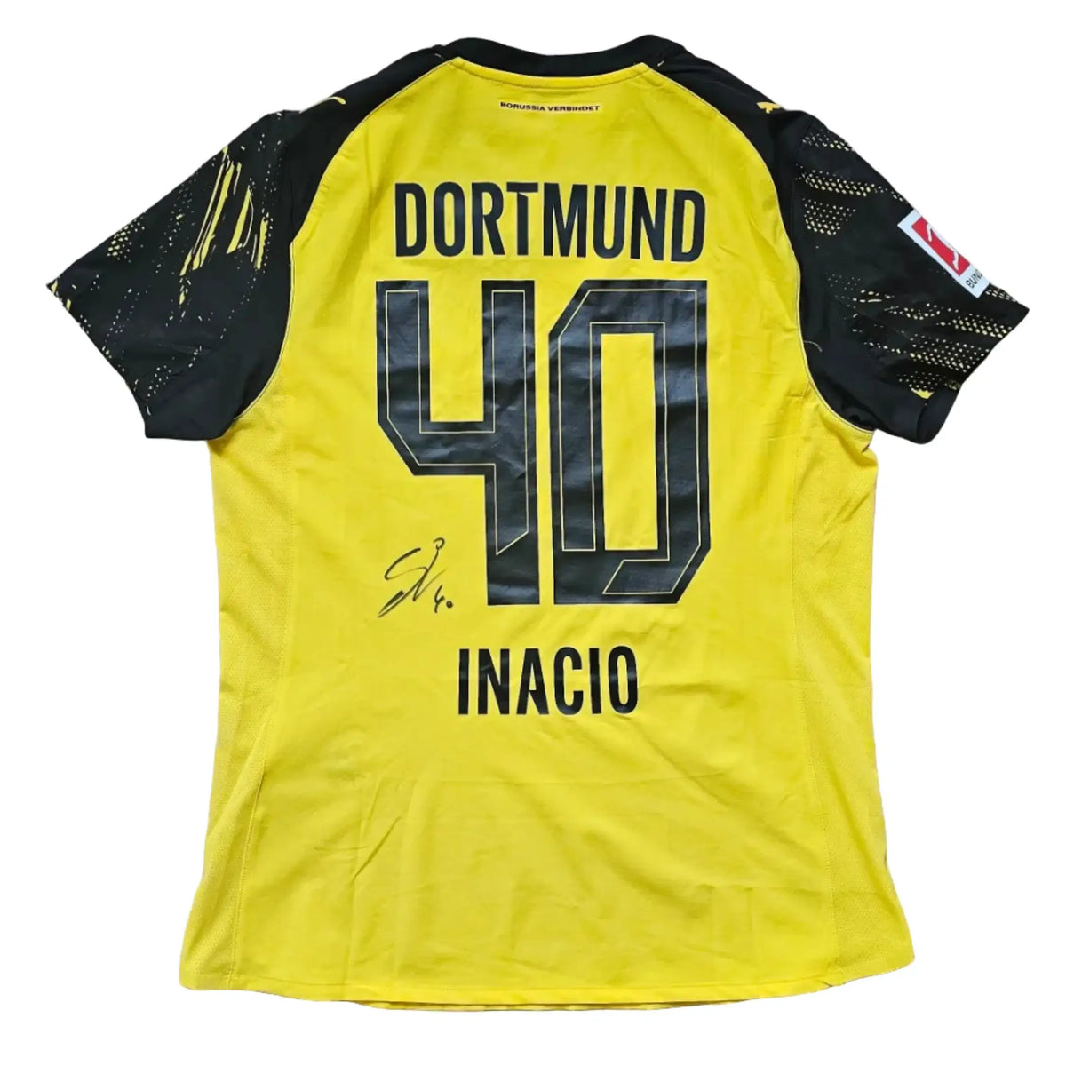Back view showcasing Dortmund No. 40 Inácio and signature in black on a yellow football shirt.