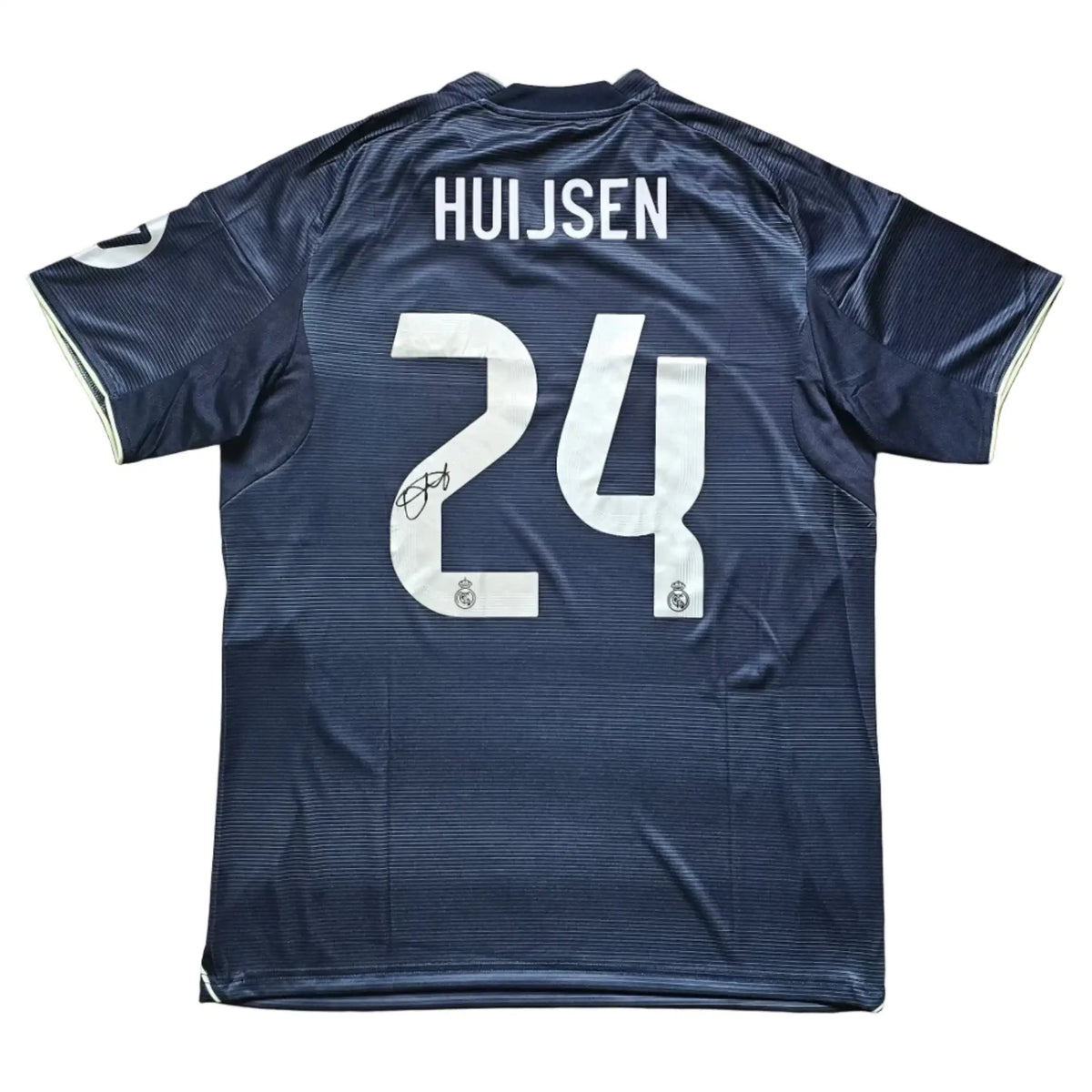 Real Madrid 2025-26 away shirt back in navy, printed HUIJSEN above the number 24, with a handwritten signature below.