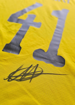 Close-up of signature on yellow shirt featuring No. 41 in grey.