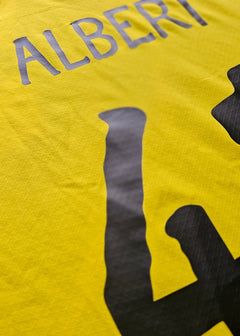 Detail view showing player name ALBERT and No. 41 on a yellow Borussia Dortmund football shirt.