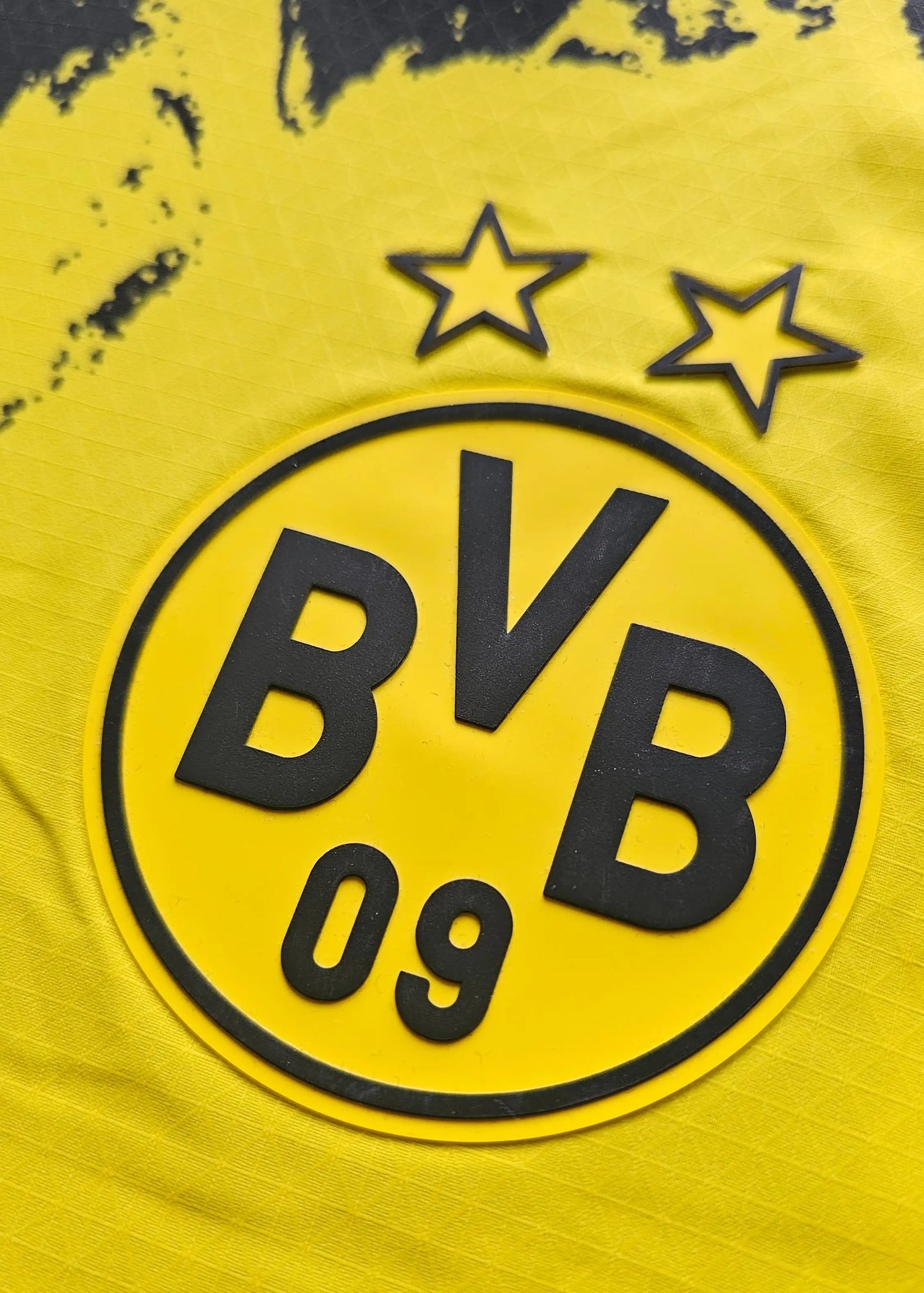 Close-up of Borussia Dortmund crest with two stars and BVB 09 in yellow and black.