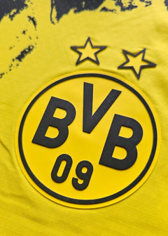 Close-up of Borussia Dortmund crest with two stars and BVB 09 in yellow and black.