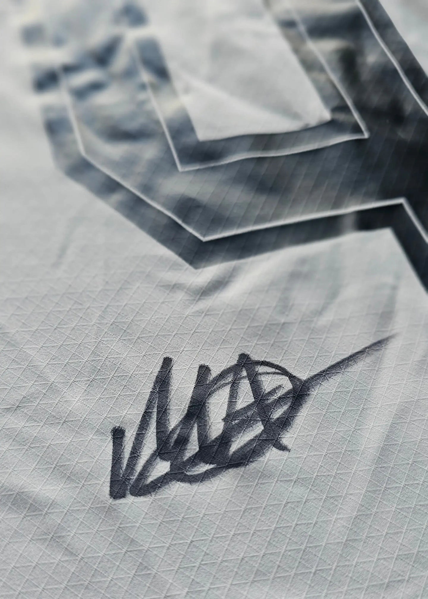 Close-up of Mathis Albert's signature on the Borussia Dortmund football shirt.